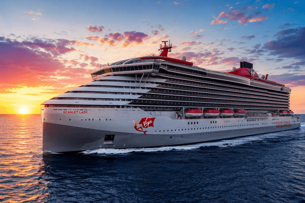 Virgin Cruises Reviews – Scarlet Lady sailing at sunset on a Virgin Voyages cruise.